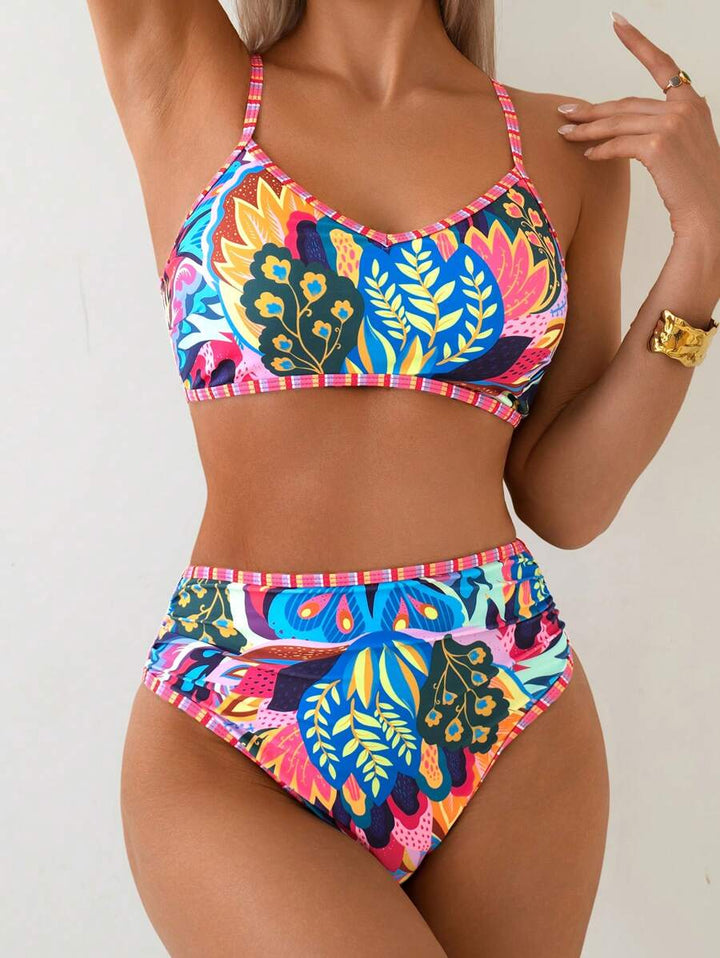Modisches Damen High-Waist Bikini-Set in Blau mit tropischem Muster. Perfekter Zweiteiler für Sommer & Urlaub.