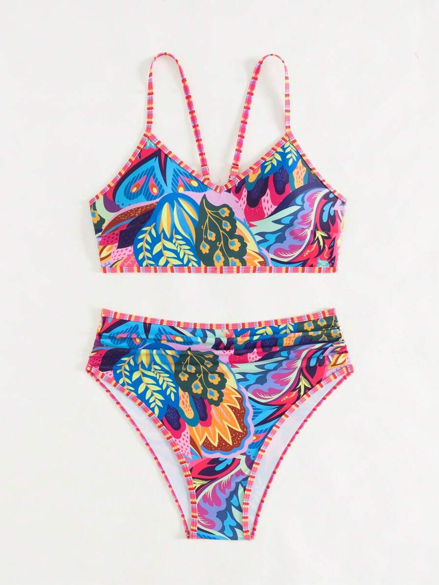 Damen High-Waist Bikini in Blau mit tropischem Muster am Pool. Komfortable Bademode für aktive Sommertage.
