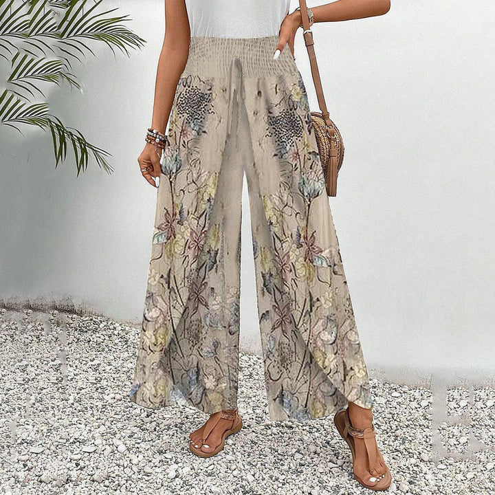 Aprikosenfarbene Damen Sommerhose, locker geschnitten, mit stilvollem Blumenmuster und elastischem Bund, sehr bequem.