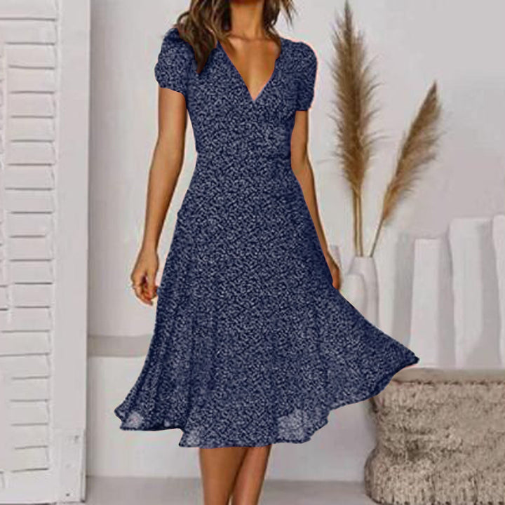 Damen Wickel-Midikleid in A-Linie. Feminines Sommerkleid mit eleganten Puffärmeln und tiefem V-Ausschnitt.