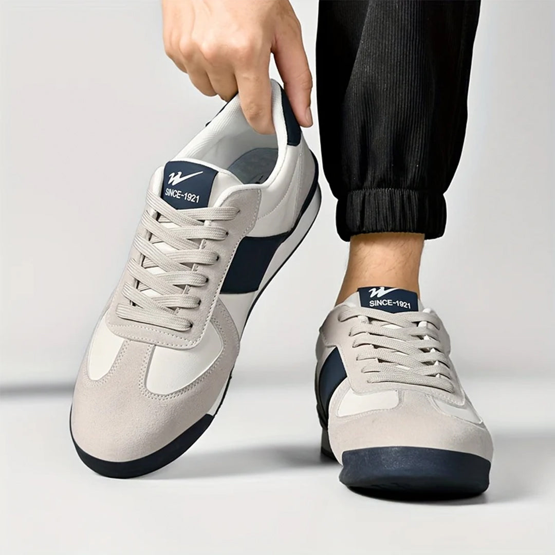 Robuster Herren-Sportschuh, stilvoll und komfortabel, mit markanten Streifen für den sportlichen Look.