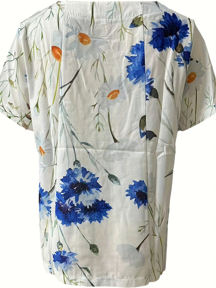 Feminine Vintage Damenbluse mit farbenfrohem Blumenmuster und klassischer Knopfleiste für den Sommer.