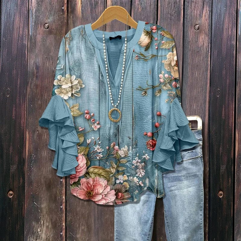 Damen Bluse mit buntem Blumenmuster, langen Rüschenärmeln und Rundhalsausschnitt. Modische Frühlingsbluse.