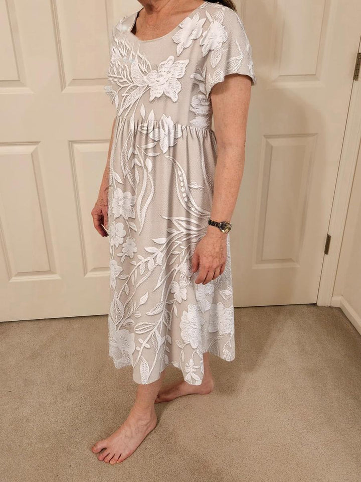 Stilvolles Damen Midikleid mit exklusivem Print-Design, kurzen Ärmeln und Seitentaschen für den Sommer.