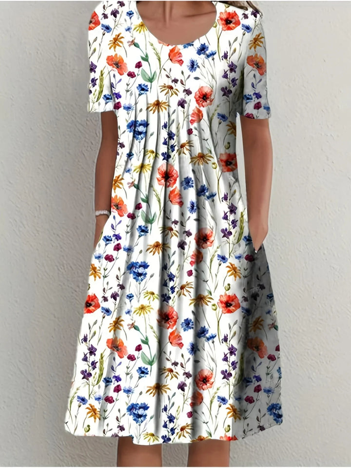 Elegantes Damen Kurzarmkleid mit farbenfrohem Blumenmuster, fließend für Sommerfeste & Gartenpartys.