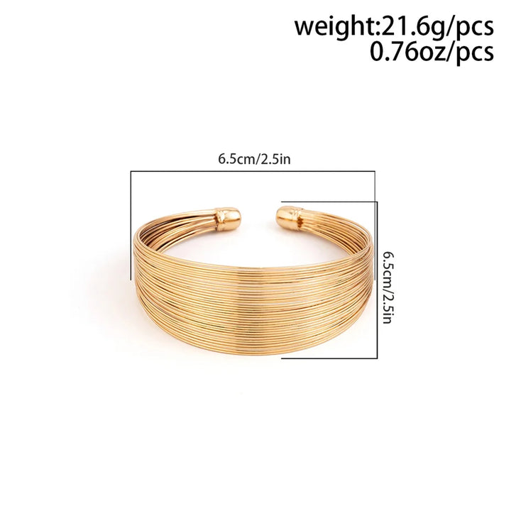 Polierter Edelstahl Manschettenarmreif für Damen, erhältlich in glänzendem Gold und Silber, ein elegantes Accessoire.