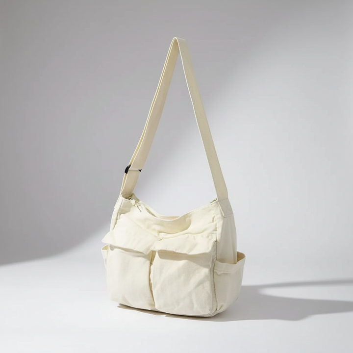 Kollektion: Grüne, braune, schwarze und weiße Unisex Canvas Satchel-Taschen nebeneinander.