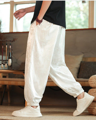 Herren-Freizeithose mit detailliertem Jacquard-Drachenmuster, Kordelzugbund und konischem Bein für lässigen Stil.