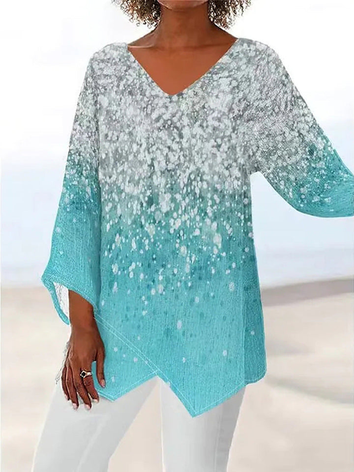 Detail der türkisen Glitzer Tunika Bluse, betont den V-Ausschnitt und den glänzenden Stoff.