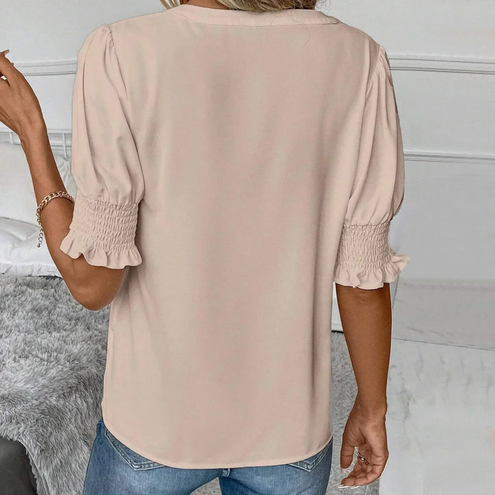Stilvolle Damenbluse mit V-Ausschnitt, modischen Puffärmeln, locker geschnitten für elegante Freizeit-Looks.