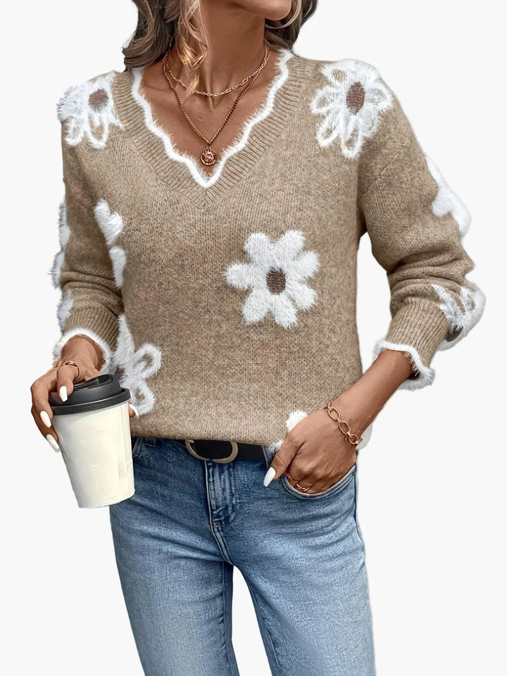 Moderner Damen Strickpullover mit blumigem V-Ausschnitt. Ein eleganter und warmer Damensweater.