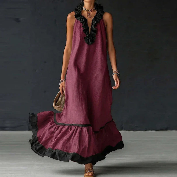 Model trägt elegantes, ärmelloses Damen Maxikleid mit V-Ausschnitt und Rüschen, ideal für festliche Anlässe.