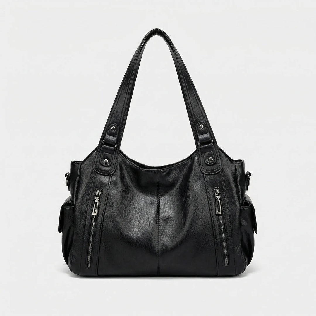 Modische Damen Crossover Tasche Nikita in Braun, als elegante Umhängetasche getragen. Perfekt für unterwegs.