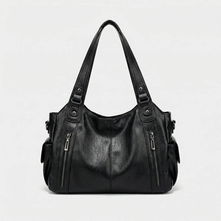 Modische Damen Crossover Tasche Nikita in Braun, als elegante Umhängetasche getragen. Perfekt für unterwegs.