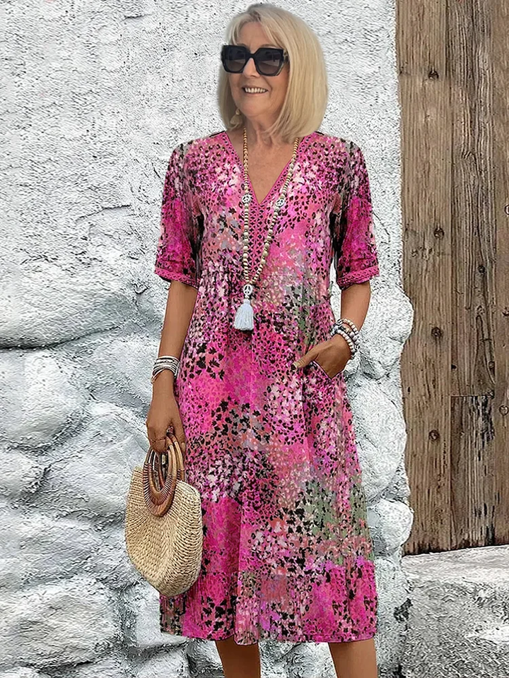 Blaues Damen Midikleid mit Blumenmuster & V-Ausschnitt. Elegantes Sommer-Urlaubskleid in A-Linie.