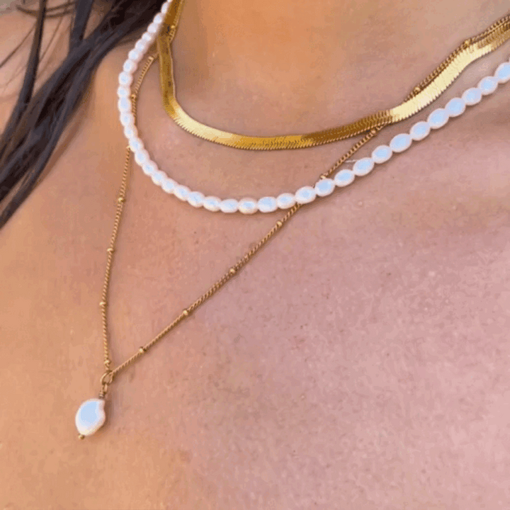 Detailaufnahme: Glänzende Gold Herringbone Choker Halskette, wasserdicht, statement für Damen.