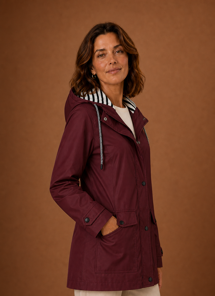 Robuster Damen Outdoor-Trenchcoat mit Kapuze in Grün. Ideal für Herbstwetter.