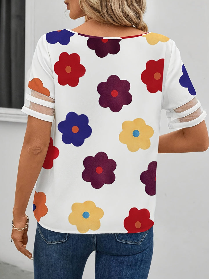 Lockere Passform Damenbluse mit Blumenmuster, asymmetrisch geschnitten, eleganter Sommer-Look.