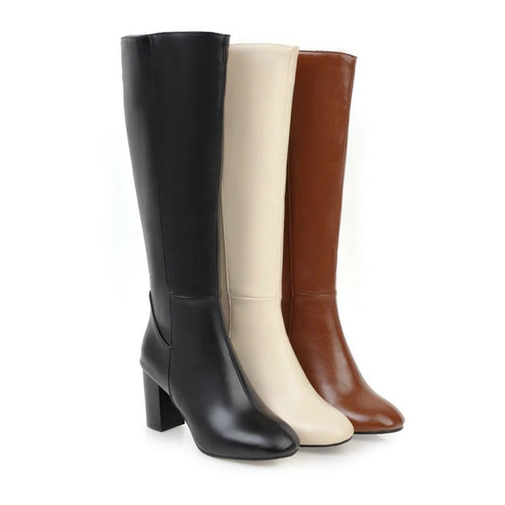 Fashion-Damenstiefel knielang in Schwarz mit Blockabsatz, kombinieren Eleganz und Tragekomfort.