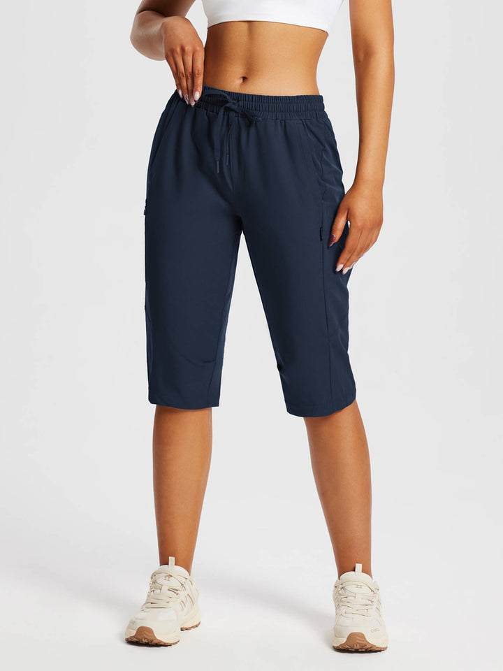Dehnbare Frauen Sport-Capris, feuchtigkeitsableitend, mit sicheren Reißverschlusstaschen.
