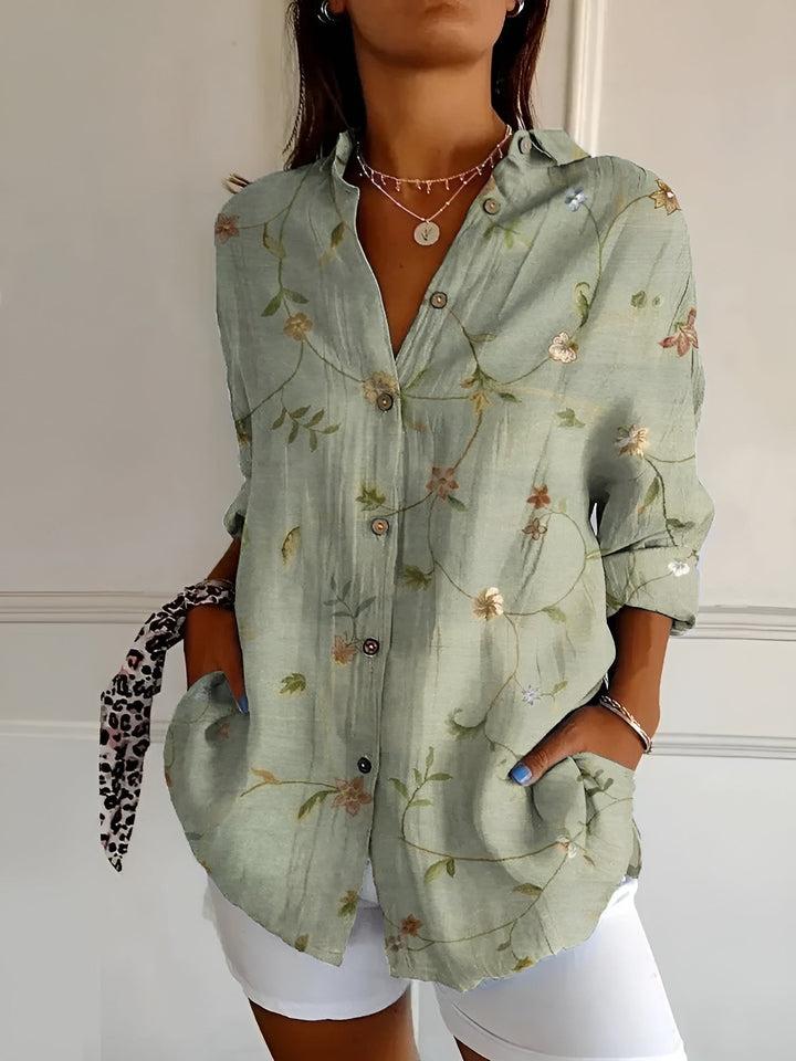 Elegante Damenbluse mit floralem Muster, langärmlig, ideal für Business Casual oder Freizeit, fließender Stoff.