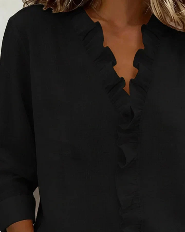 Damenbluse mit elegantem V-Ausschnitt & Dreiviertelärmeln. Ideal als Bürokleidung oder für Freizeitmode.