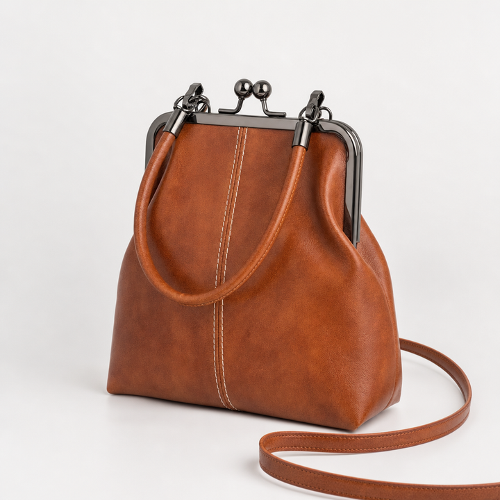 Damen Bügeltasche im Vintage-Look mit Kussverschluss aus elegantem Kunstleder, als Schultertasche tragbar.