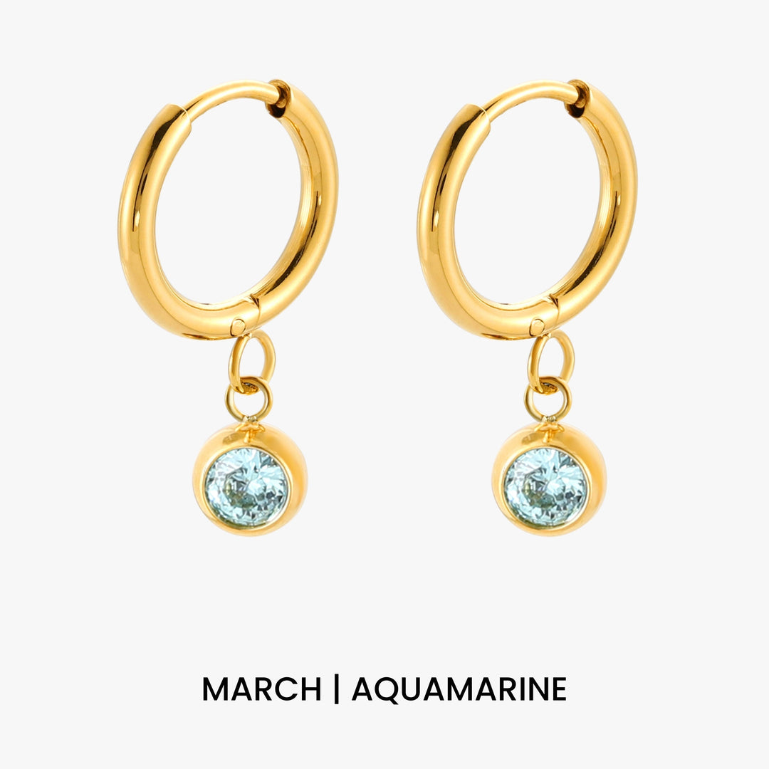 Detailansicht: Goldene Creolen mit glänzendem Zirkonia und Geburtsstein für Damen.