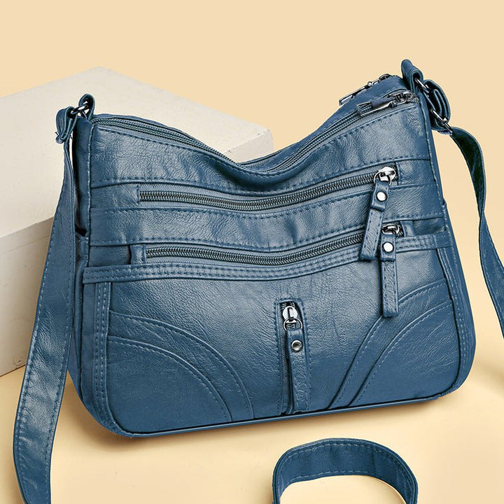 Vintage Damen Schultertasche Detail: Robuster Reißverschluss und stilvolle Schnallen, für sichere Organisation.