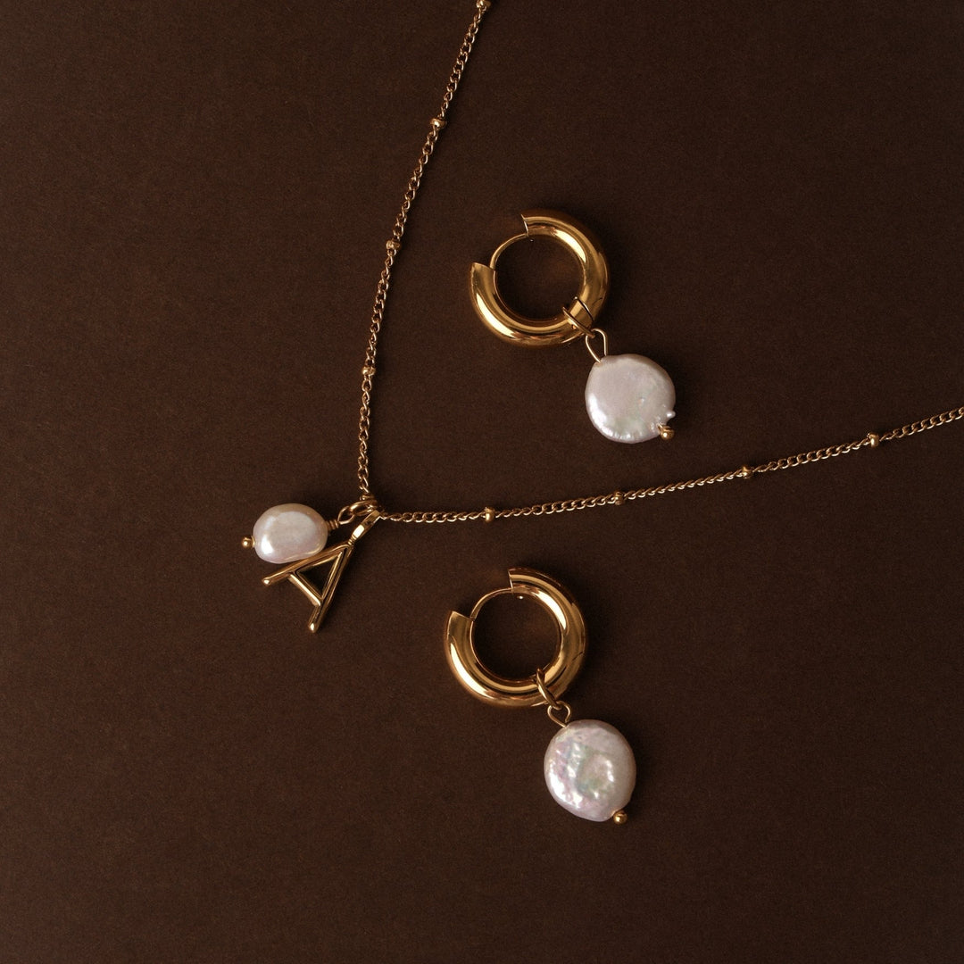 Zeitlose Damenhalskette: Goldkette mit Barockperle & Initial Anhänger, elegant & vielseitig.