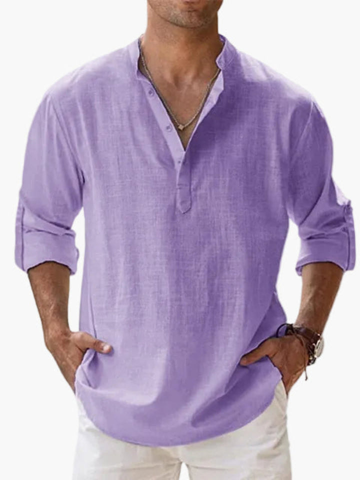 Mann trägt hellblaues Henley Hemd mit Krempelärmeln, entspannter Sommerstil, perfekt für Freizeit.