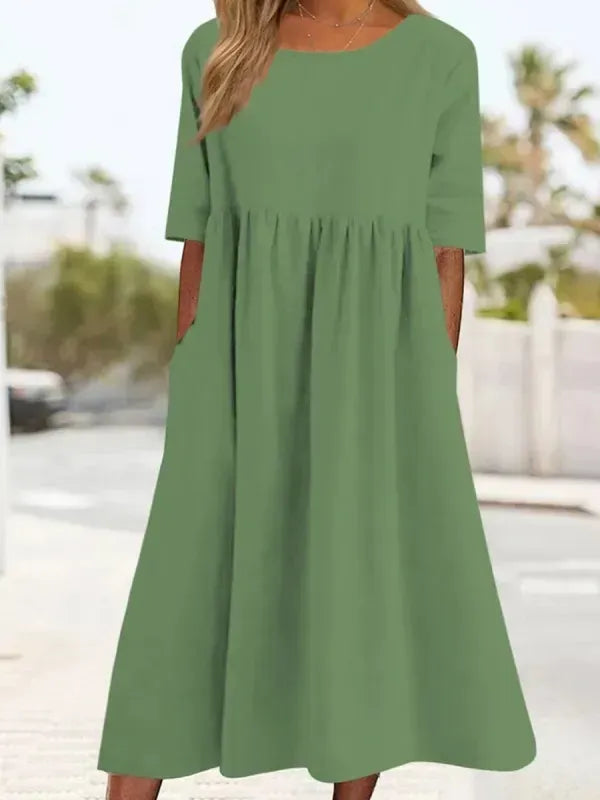 Stylisches Damen Sommerkleid, locker geschnitten, mit Rundhals, Kurzarm & praktischen Taschen.