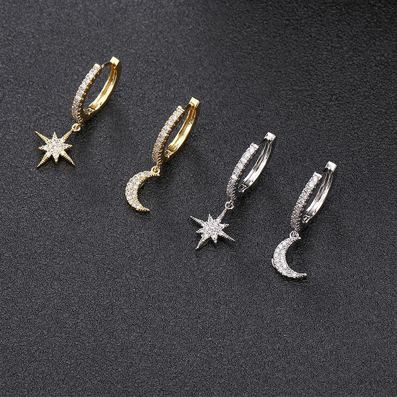 Detailaufnahme von wasserfesten Hängeohrringen: Funkelnder Mond & Stern Anhänger mit Zirkonsteinen in Silberoptik.