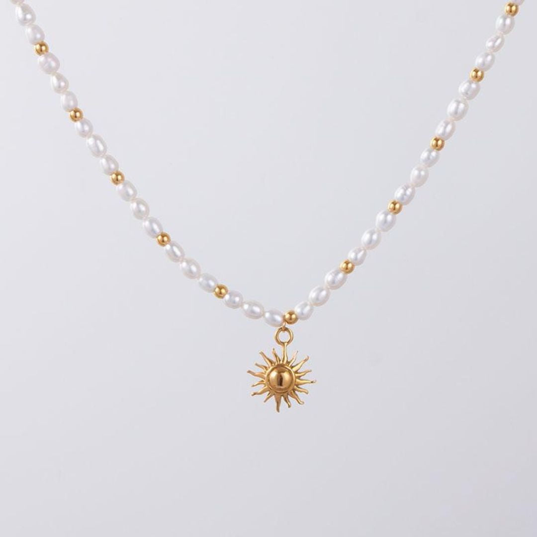 Nahaufnahme einer Damenhalskette aus Gold mit schimmernden Süßwasserperlen, eleganter Schmuck.